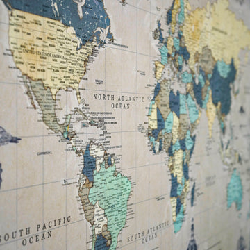 Side-angle close-up of the Americas and North Atlantic on the vintage world map canvas in slate blue and teal