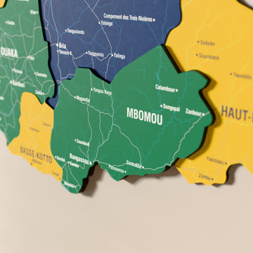 Close-up of the Flag colored Central African Republic wooden wall map with layered regions and printed names