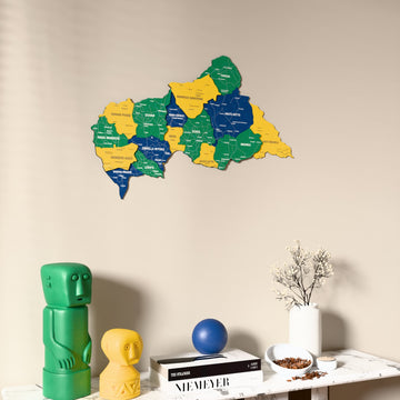 Flag colored Central African Republic wooden wall map on a beige wall above a console with figurines