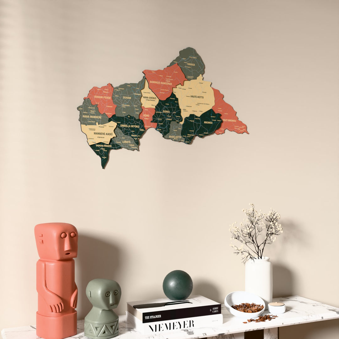 Sage Central African Republic wooden wall map on a beige wall above a console with figurines