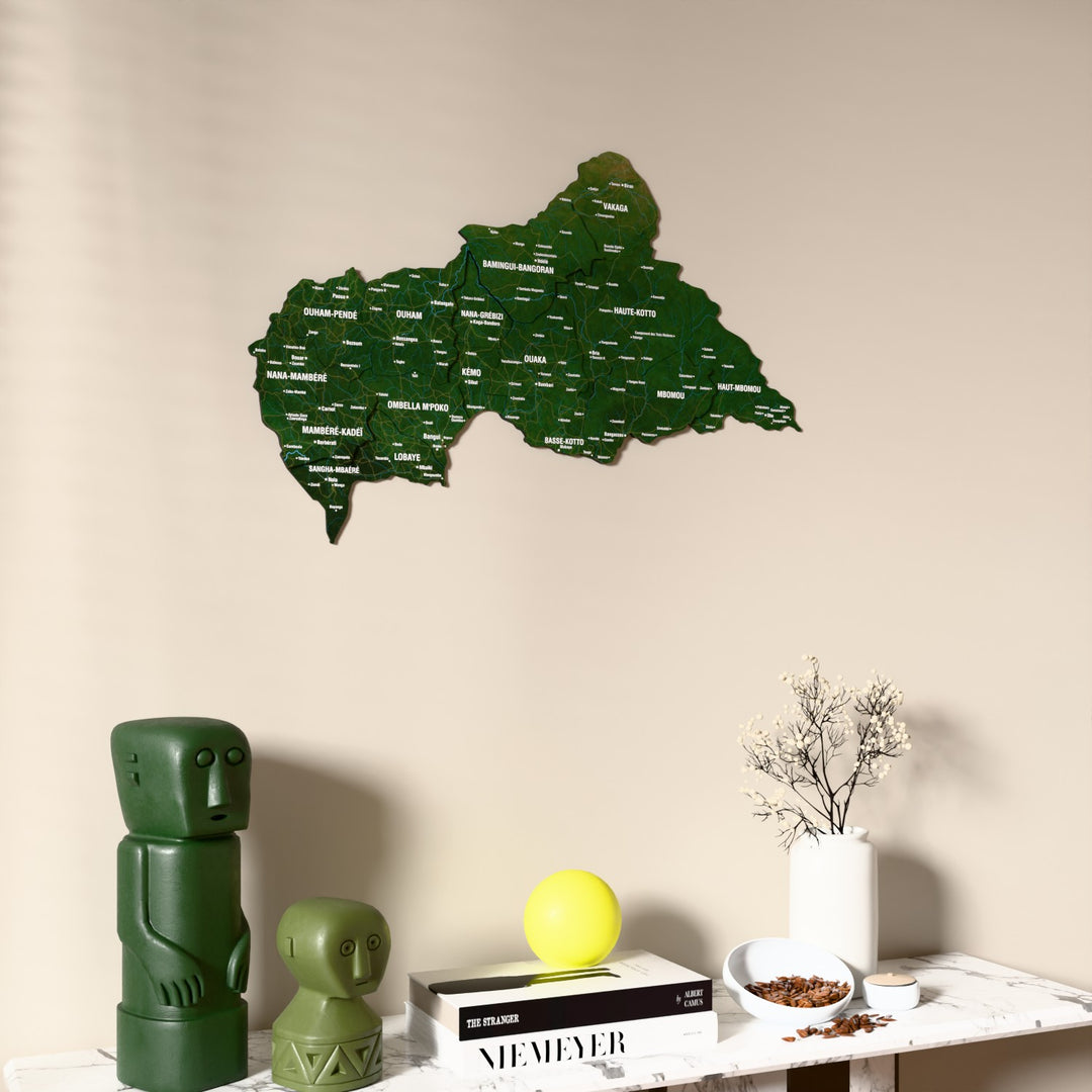 Satellite Central African Republic wooden wall map on a beige wall above a console with figurines