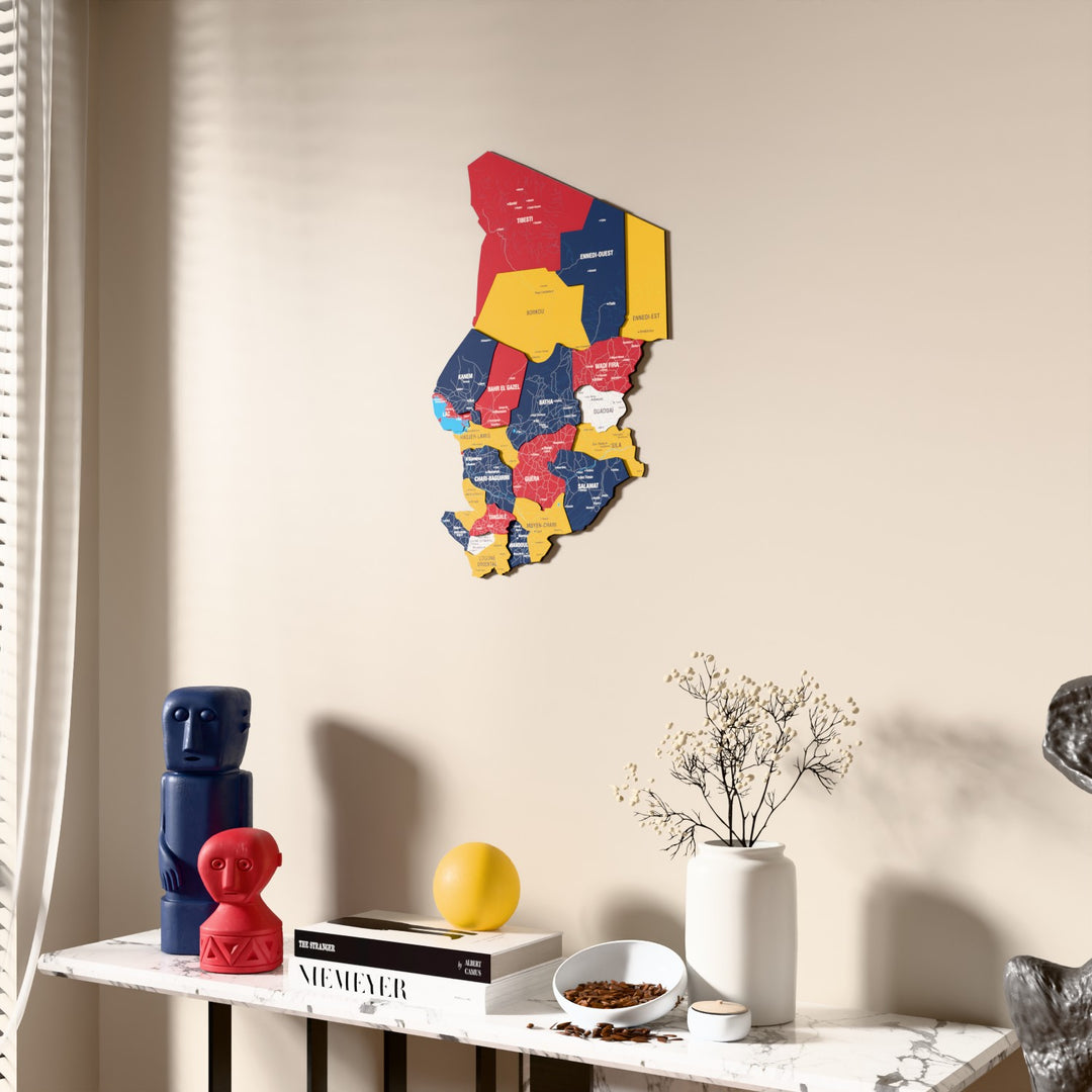 Flag colored Chad wooden wall map beside a sheer curtain, angled view