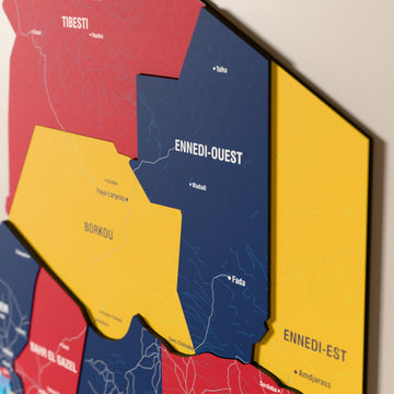 Close-up of the Flag colored Chad wooden wall map with layered regions and printed names