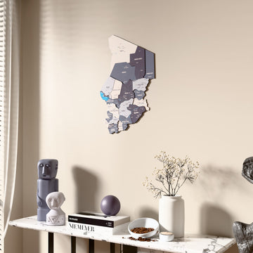 Nimbus Chad wooden wall map beside a sheer curtain, angled view