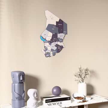 Nimbus Chad wooden wall map on a beige wall above a console with figurines