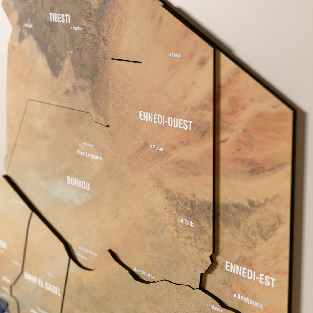 Close-up of the Satellite Chad wooden wall map with layered regions and printed names