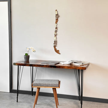 Chile wood wall map beside a desk and stool, view from a lower angle