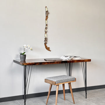 Wooden Chile wall map beside a desk and stool, wide view of the wall