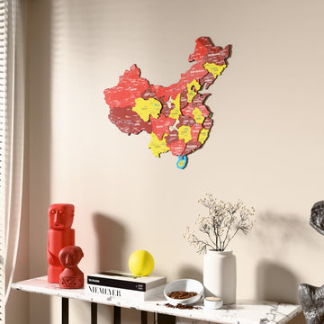 Flag colored China wooden wall map beside a sheer curtain, angled view