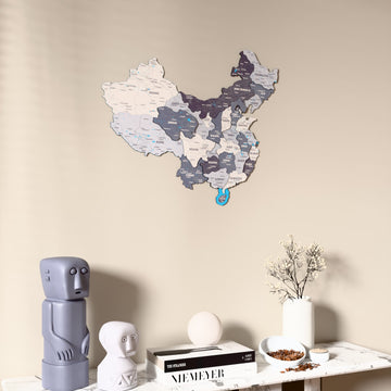 Nimbus China wooden wall map on a beige wall above a console with figurines