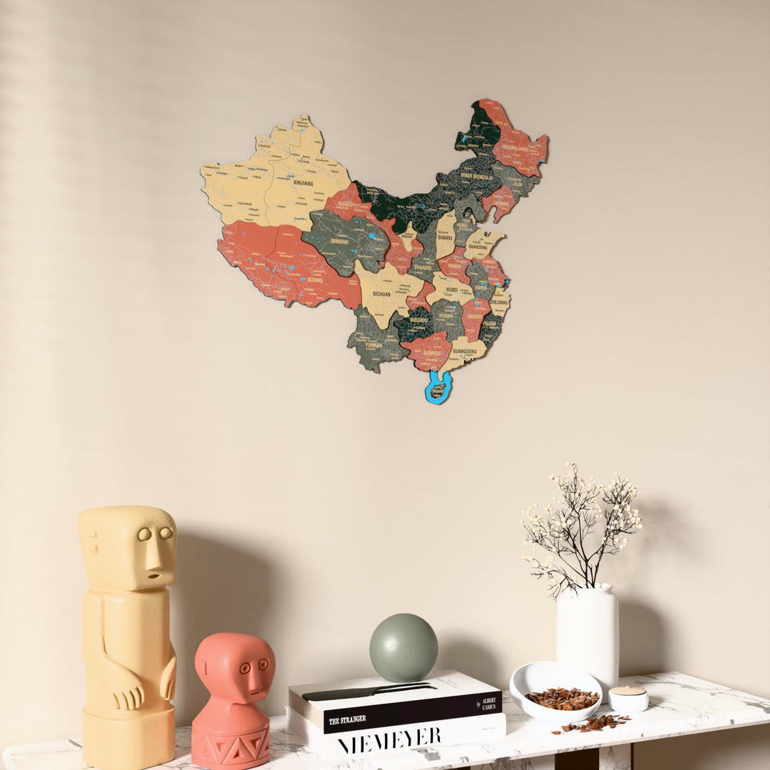 Sage China wooden wall map on a beige wall above a console with figurines
