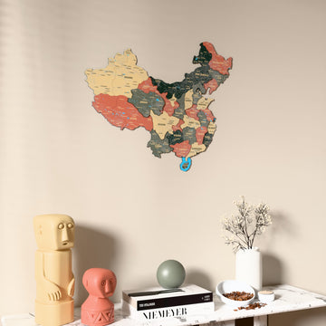 Sage China wooden wall map on a beige wall above a console with figurines