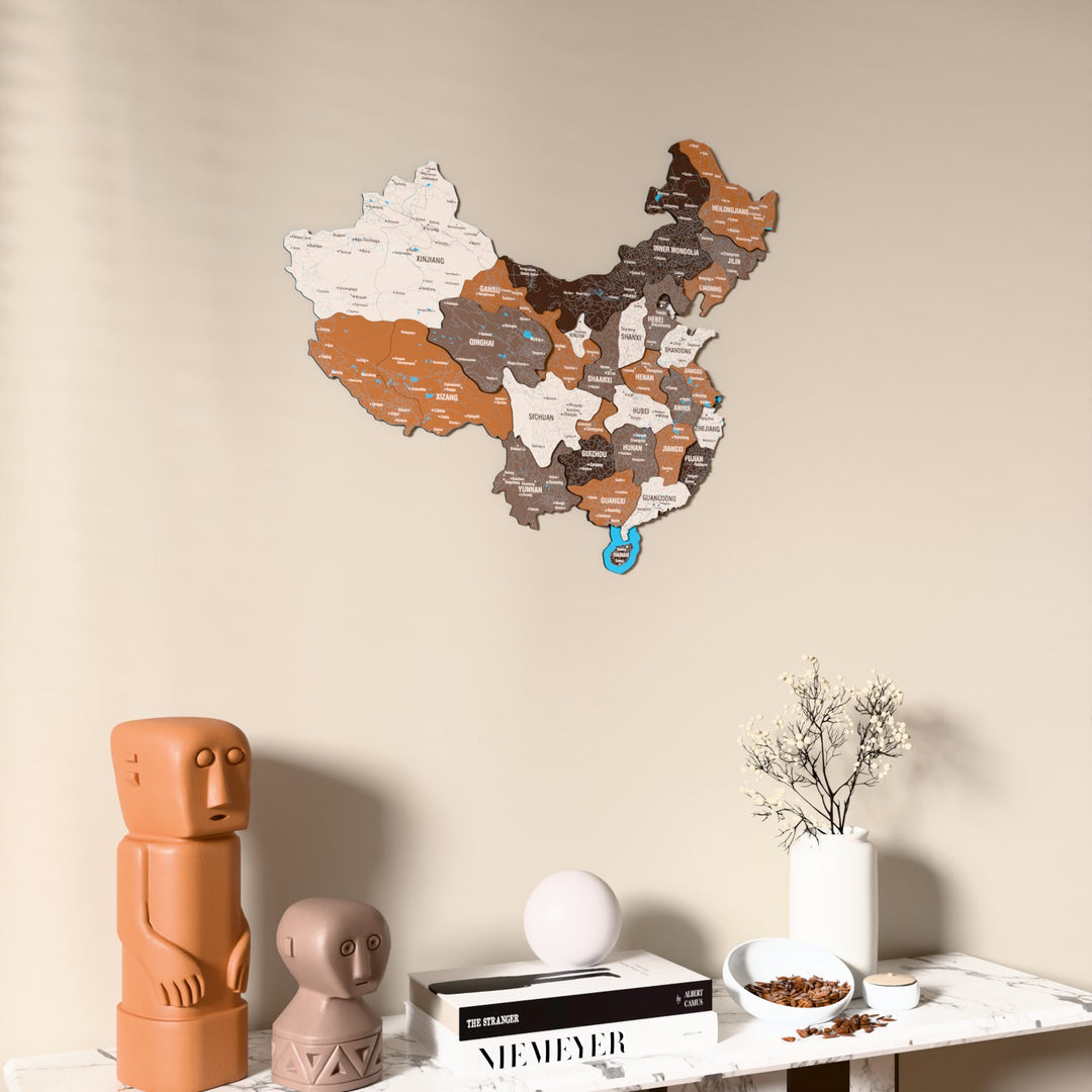 Soil China wooden wall map on a beige wall above a console with figurines