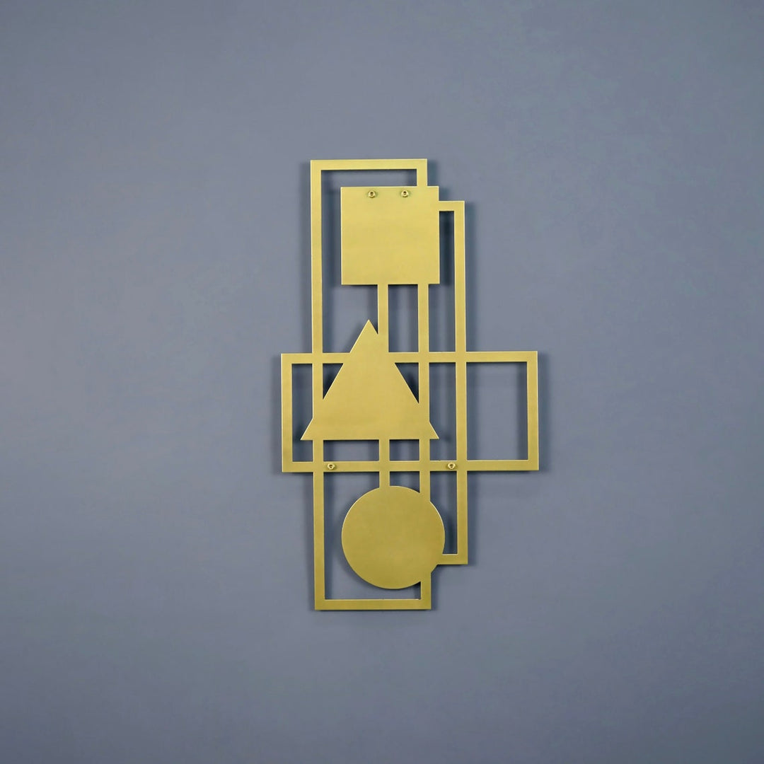 Gold abstract geometric metal wall art with square, triangle and circle on a blue-grey wall