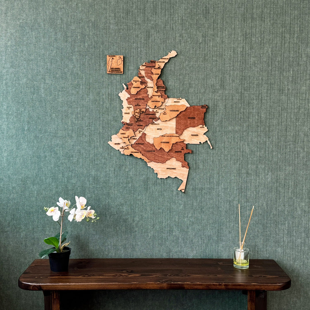 Wooden Colombia wall map with department names and a San Andrés panel, above a console table