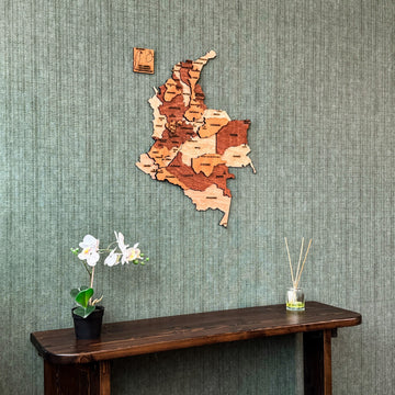 Colombia plywood wall map above a dark console with an orchid, centered view