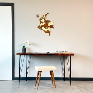 Colombia wooden wall map above a console table with iron legs and a cream stool