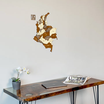 Colombia multicolor wooden map above a resin edge desk with a laptop, close crop