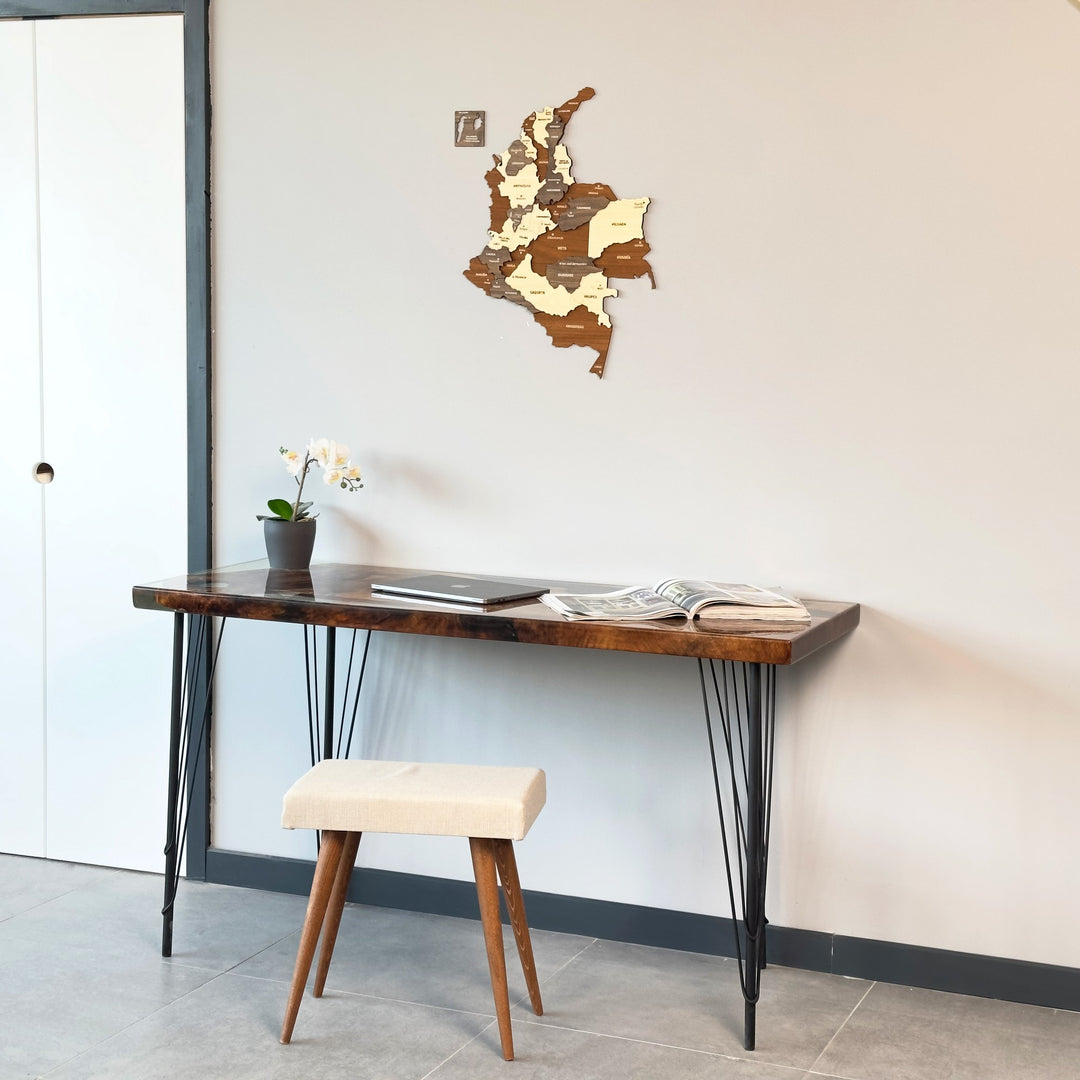 Colombia wooden wall map next to a white door above a console table with a cream stool