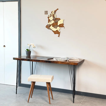 Colombia wooden wall map next to a white door above a console table with a cream stool