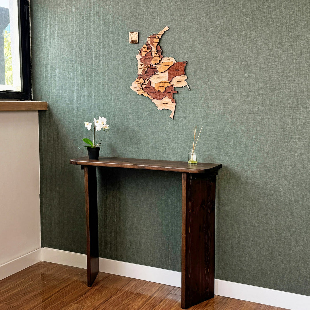 Colombia wooden wall map above a console table, wide room view with a window edge