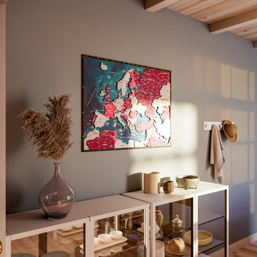 Wooden Europe map with rivers in Crimson, above a shelf unit with a pampas vase