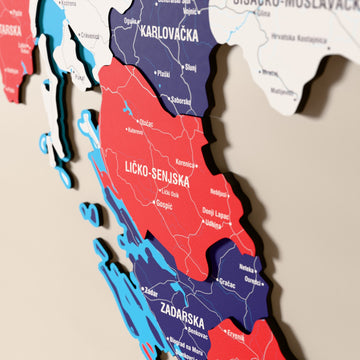 Close-up of the Flag colored Croatia wooden wall map with layered regions and printed names