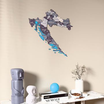 Nimbus Croatia wooden wall map on a beige wall above a console with figurines
