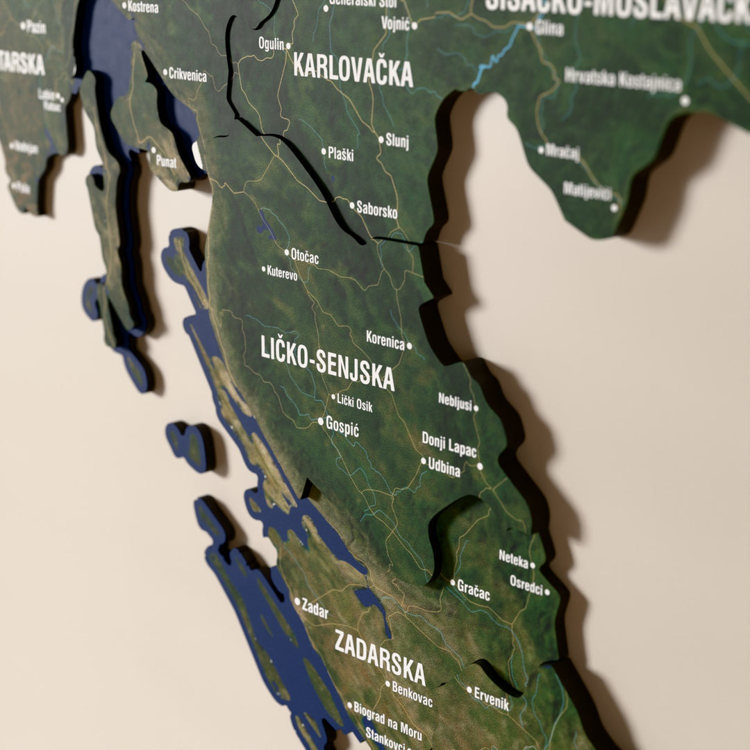 Close-up of the Satellite Croatia wooden wall map with layered regions and printed names