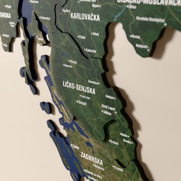 Close-up of the Satellite Croatia wooden wall map with layered regions and printed names