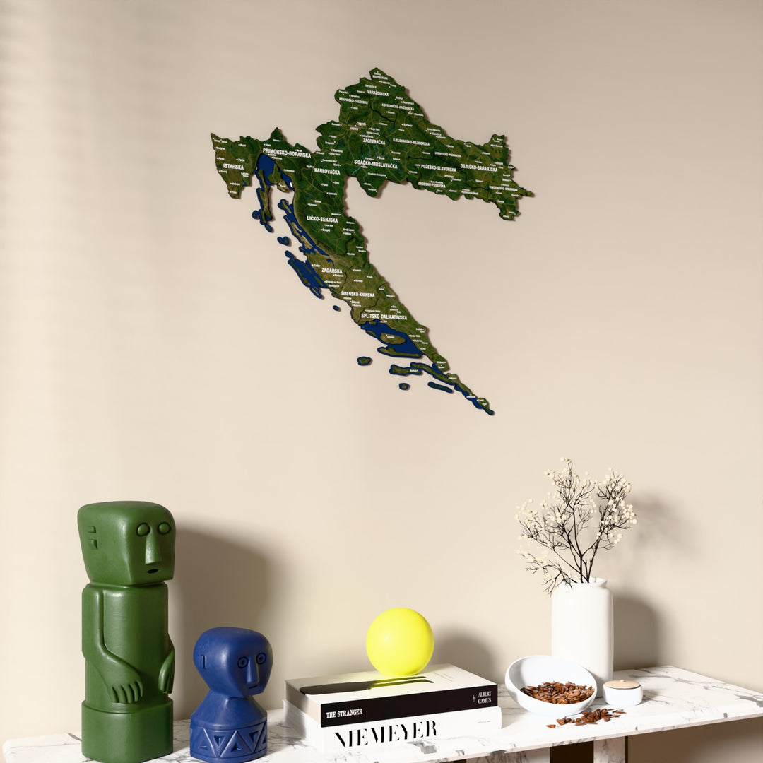 Satellite Croatia wooden wall map on a beige wall above a console with figurines
