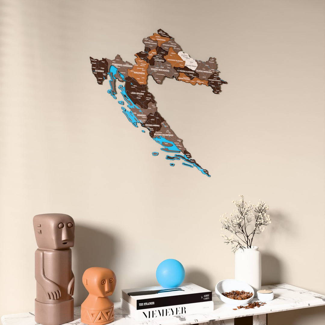 Soil Croatia wooden wall map on a beige wall above a console with figurines