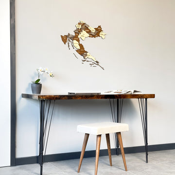 Croatia wooden wall map above a desk with a cream stool, seen from the left side