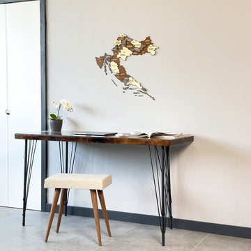 Croatia wood map on a gray wall beside a white door frame, desk and stool below