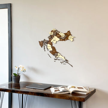 Croatia wooden map with regional panels above a resin edge desk with a laptop