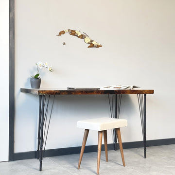 Cuba wooden wall map on a gray wall above a hairpin-leg desk