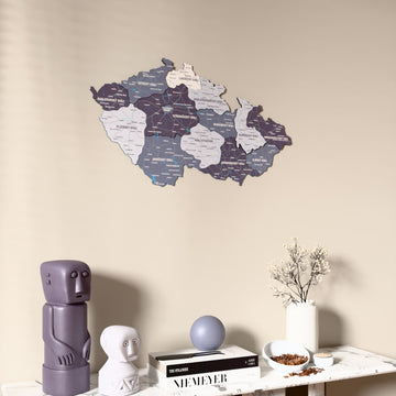 Nimbus Czech Republic wooden wall map on a beige wall above a console with figurines