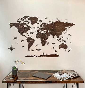 Dark brown wooden world map with country names above a glass-top resin desk