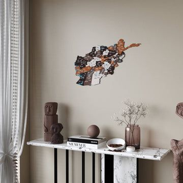 Soil Afghanistan wooden wall map in dark brown and rust pieces above a console, curtain at the left