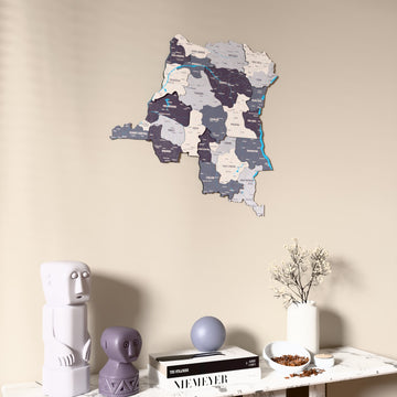 Nimbus Democratic Republic of the Congo wooden wall map on a beige wall above a console with figurines