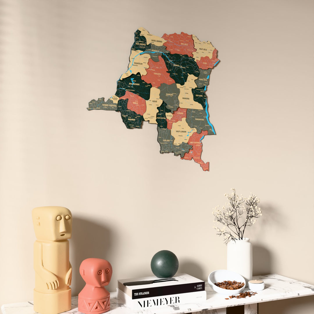 Sage Democratic Republic of the Congo wooden wall map on a beige wall above a console with figurines