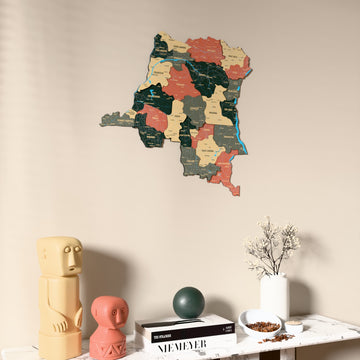 Sage Democratic Republic of the Congo wooden wall map on a beige wall above a console with figurines