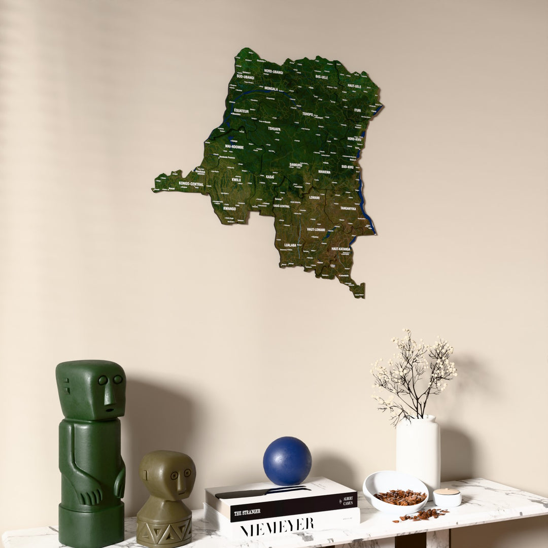 Satellite Democratic Republic of the Congo wooden wall map on a beige wall above a console with figurines
