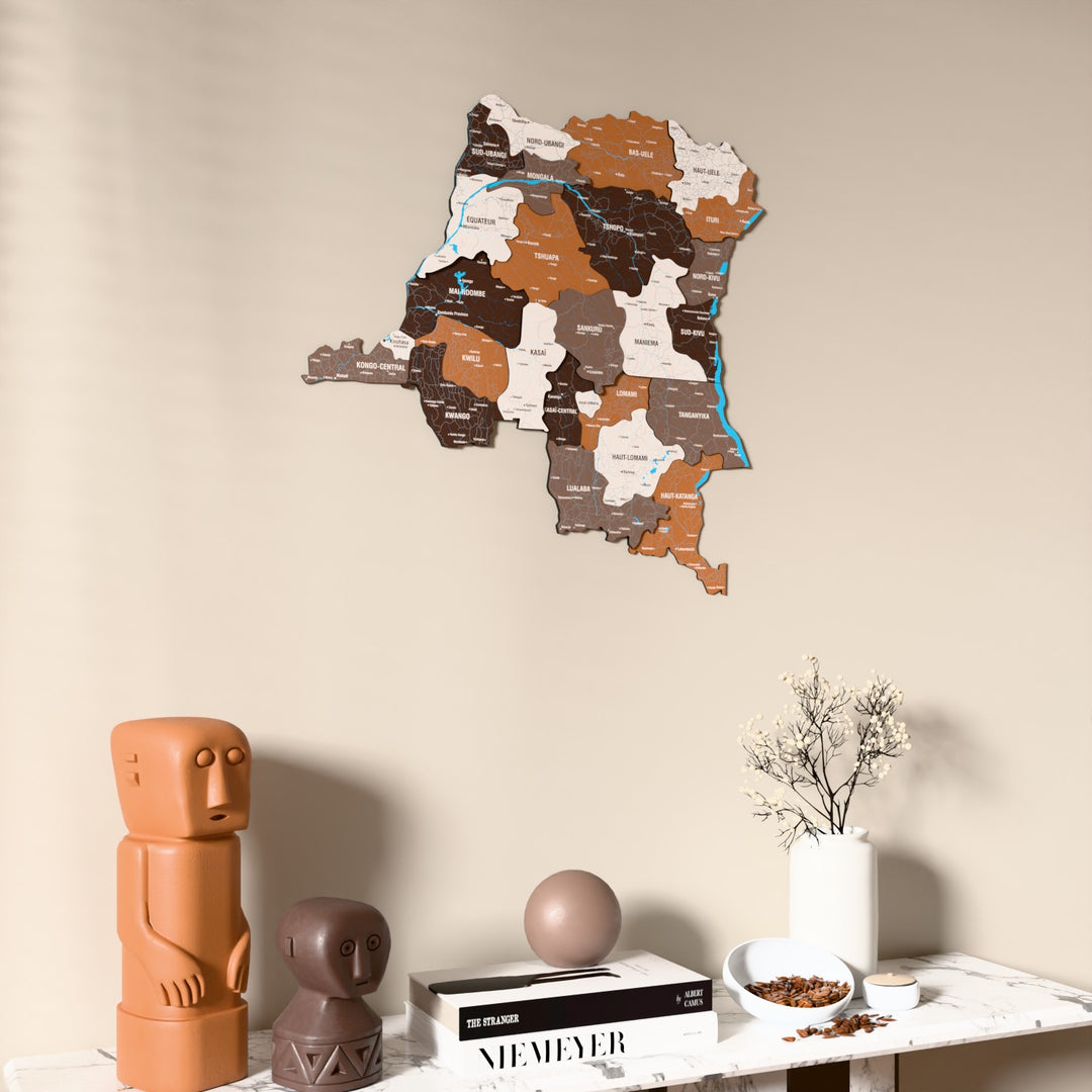 Soil Democratic Republic of the Congo wooden wall map on a beige wall above a console with figurines