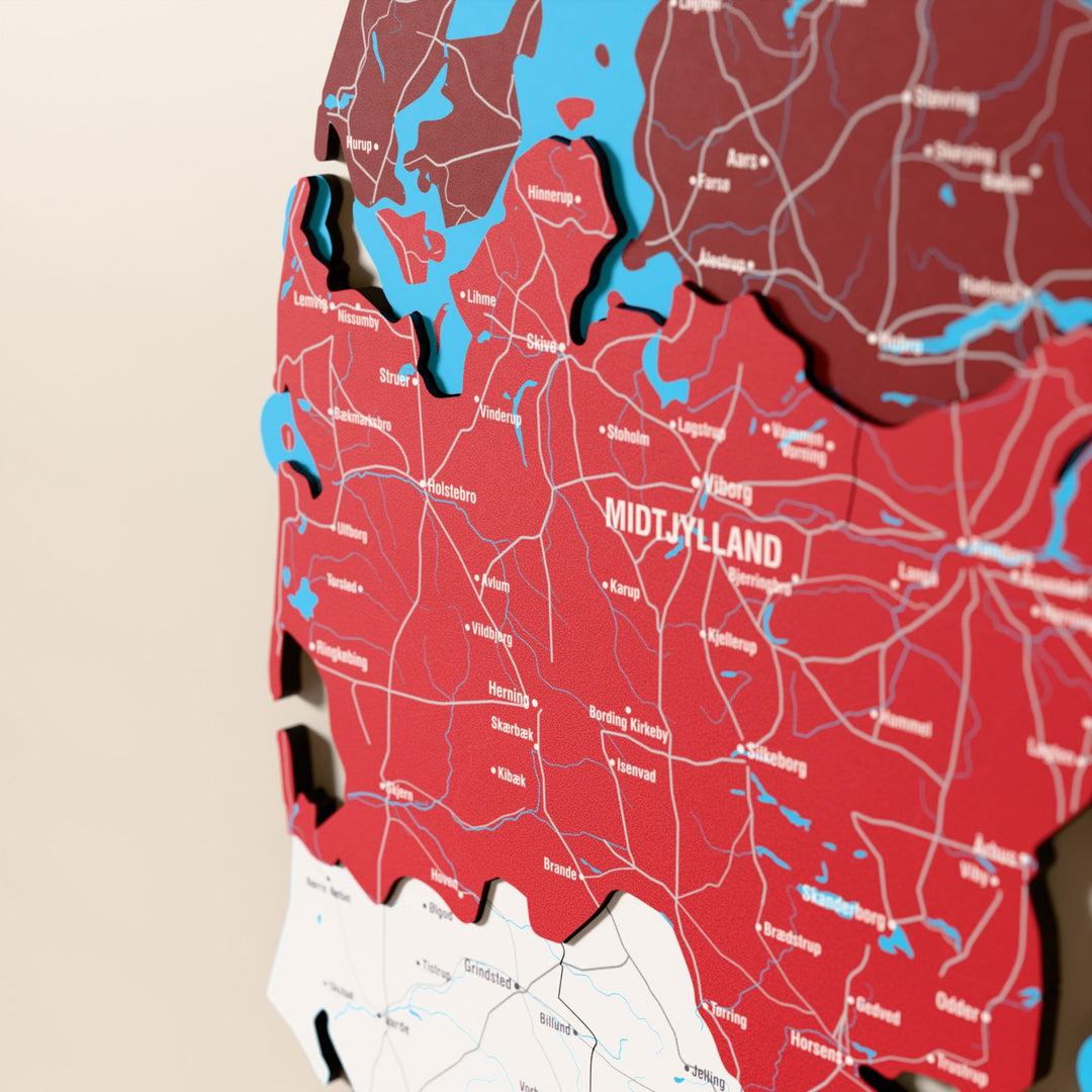 Close-up of the Flag colored Denmark wooden wall map with layered regions and printed names