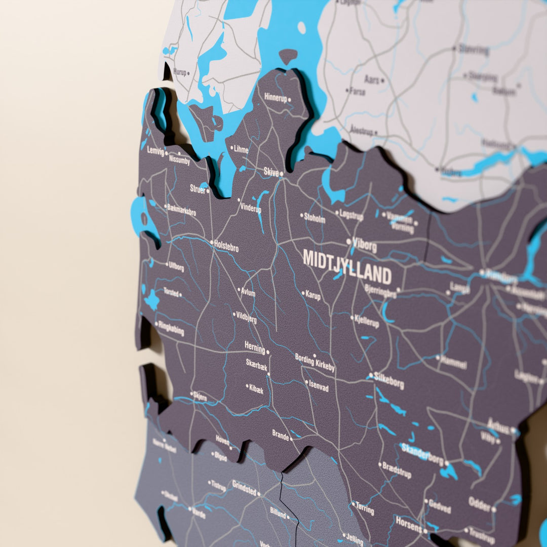 Close-up of the Nimbus Denmark wooden wall map with layered regions and printed names
