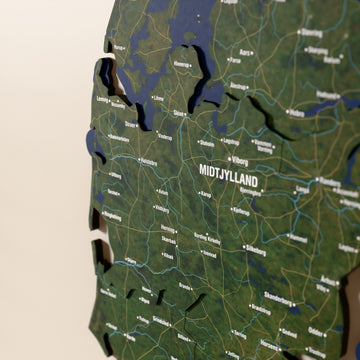 Close-up of the Satellite Denmark wooden wall map with layered regions and printed names
