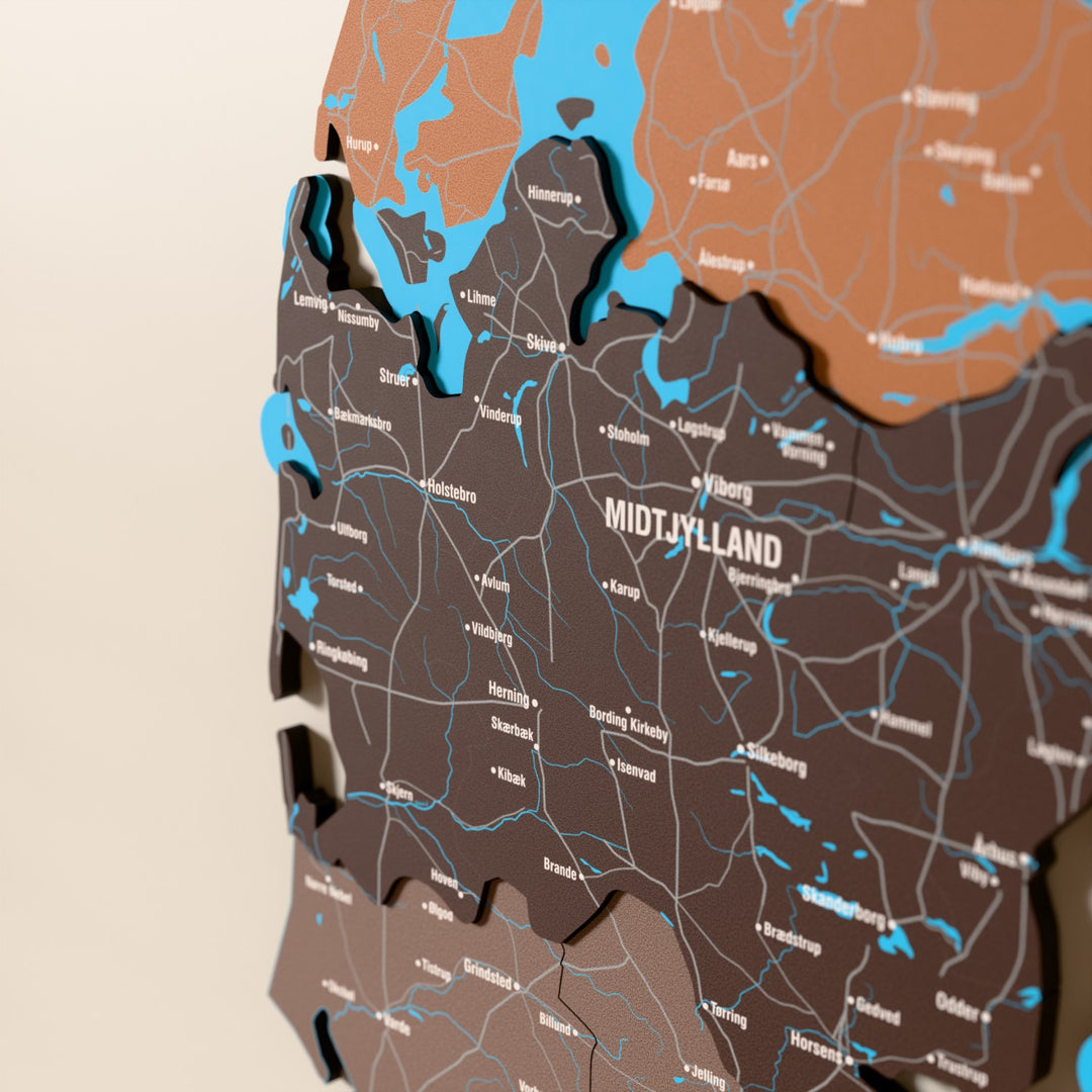 Close-up of the Soil Denmark wooden wall map with layered regions and printed names