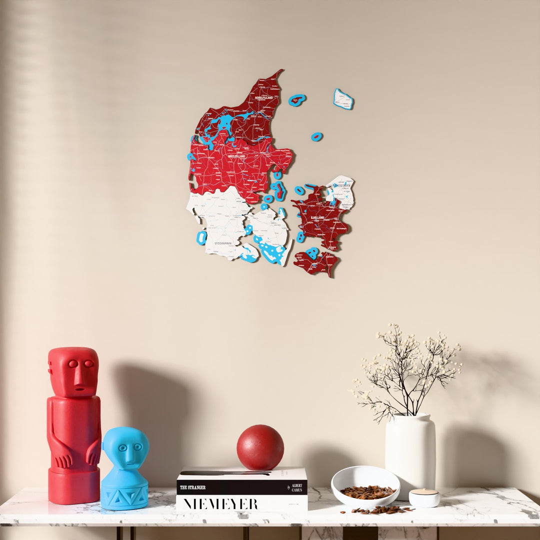 Flag colored Denmark wooden wall map above a marble console, front view