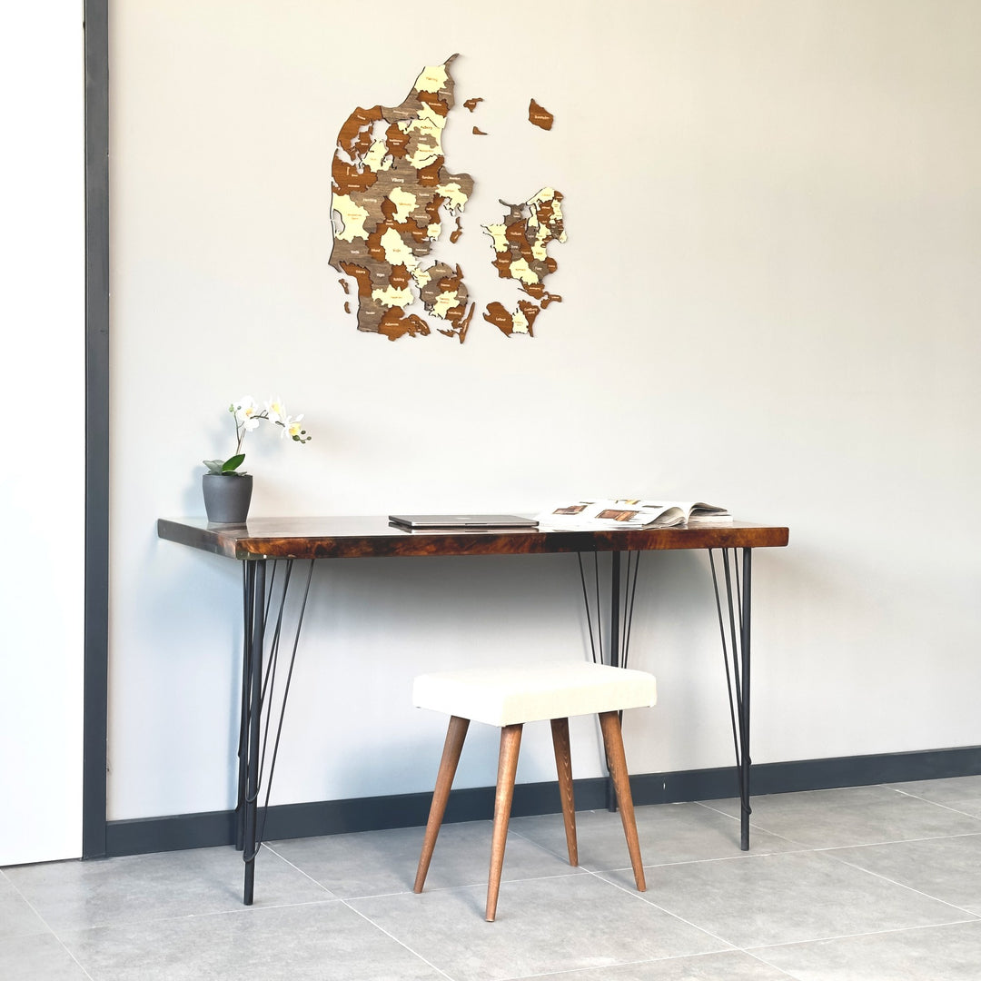Denmark wooden wall map on a gray wall above a hairpin-leg desk
